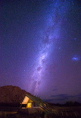 Milky way over a small chalet of a desert lodge near Sossusvlei in Namibia