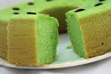 Green tea flavored sponge bread light green with raisin seeds above it