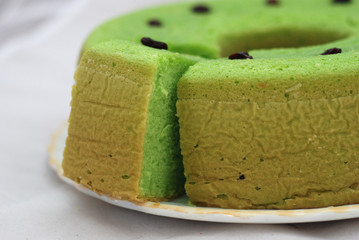 Green tea flavored sponge bread light green with raisin seeds above it