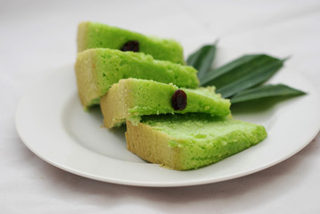 Green tea flavored sponge bread light green with raisin seeds above it