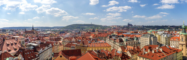 Fototapeta na wymiar Outdoor sunny panoramic aerial scenery of rooftop in old town, city skyline, Charles Bridge tower and background range of mountain with Prague Castle and St. Vitus Cathedral in Prague, Czech Republic.