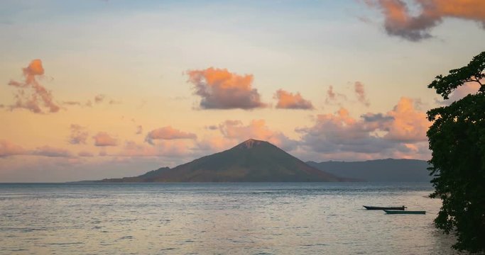 Time lapse sunset to night colorful sky over active volcano Gunung Api view from Ai Island Banda Islands Maluku Indonesia famous for nutmeg plantations