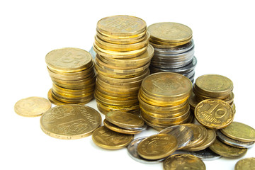 Gold towers made out of gold and silvery of Ukraine coins, stack isolated on white.