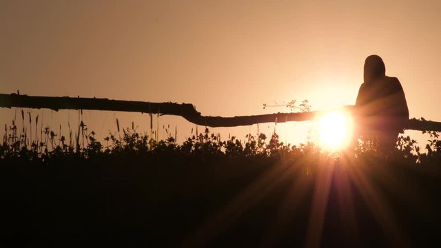 Rural scene of man going home backlight. Silhouette of man with backpack on sunset backlight background. Green tourism concept. Summer vacation background. Back home concept.