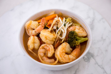 Tom Yam kung Spicy Thai soup in bowl