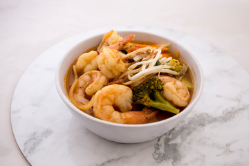 Tom Yam kung Spicy Thai soup in bowl