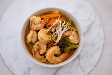 Tom Yam kung Spicy Thai soup in bowl