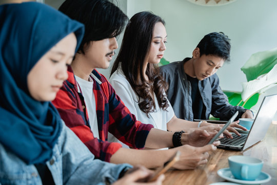 College Student Asian With Friend Working Together In Cafe