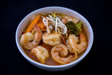 Tom Yam kung Spicy Thai soup in bowl