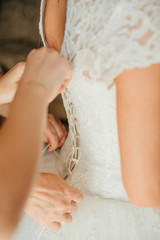 Obraz na płótnie Canvas tighten the bride's white dress