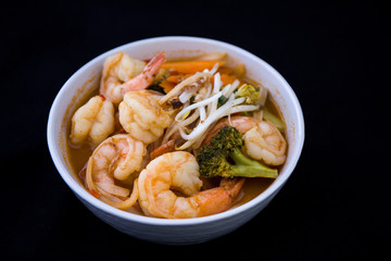 Tom Yam kung Spicy Thai soup in bowl