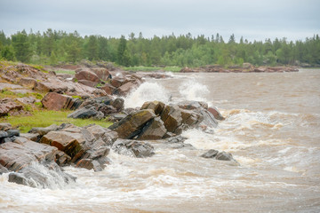 The strong waves of the White Sea crashing on the rocky shore