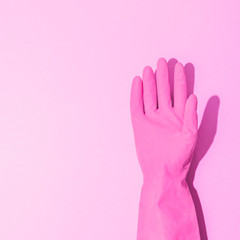 Fashion creative concept with hand in pink flamingo rubber glove, showing gesture. High five symbol. Aesthetic abstract minimalism.