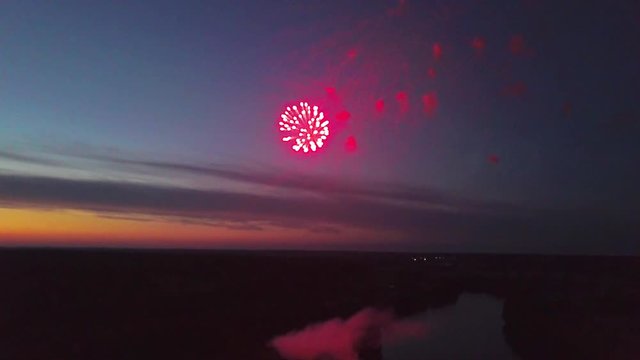 aerial late sunset firewok holiday fest reflection in the water evening night river