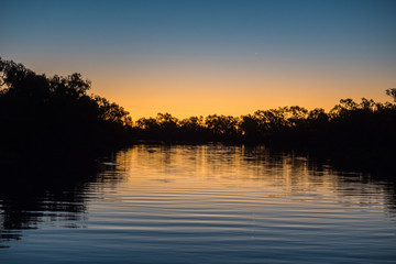 Sunset with silhouetted trees on the Thompson River, Central Queensland
