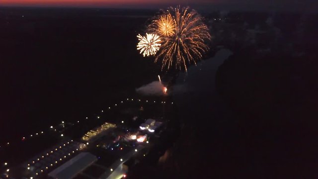 aerial late sunset firewok holiday fest reflection in the water evening night river