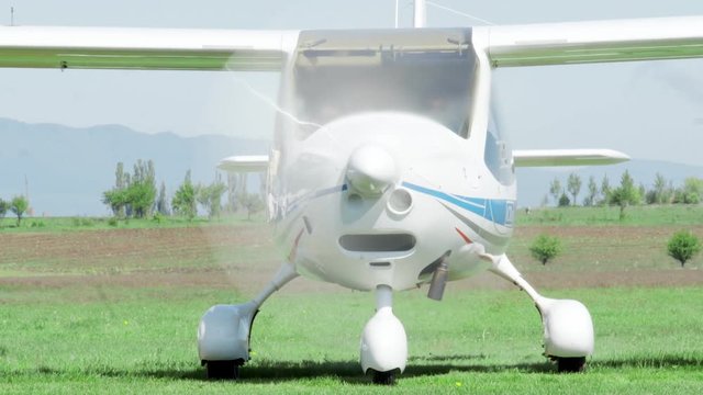 Civil plane flying in a small airdrome in the countryside