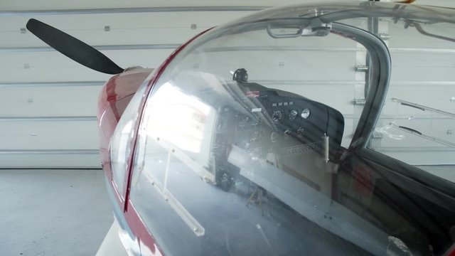 Detail of cockpit on small airplane or glider in hangar