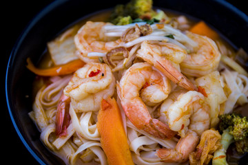 Tom Yam kung Spicy Thai soup in bowl