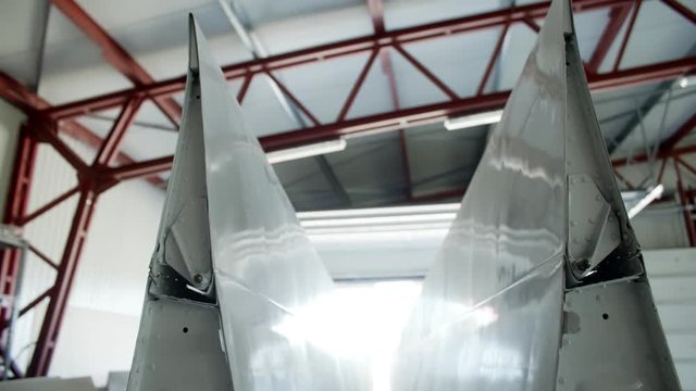 Private civil Aircraft maintenance in factory parts with fuselage and wings in service hangar