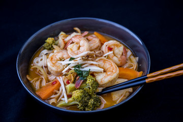 Tom Yam kung Spicy Thai soup in bowl