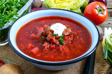 Borsch is a traditional Ukrainian dish in a bowl on the table. Tasty and healthy lunch.