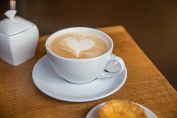 a plain cup of coffee with a heart