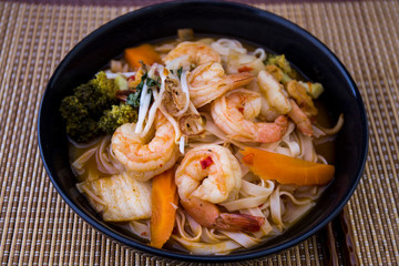 Tom Yam kung Spicy Thai soup in bowl