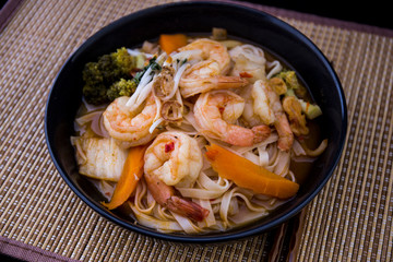 Tom Yam kung Spicy Thai soup in bowl