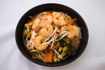 Tom Yam kung Spicy Thai soup in bowl