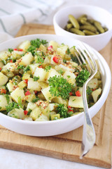 Potato salad with pickled cucumbers and parsley, mustard sauce