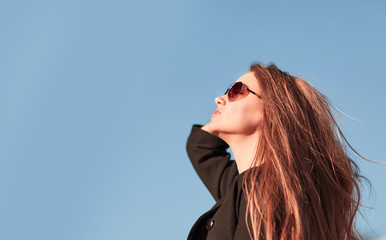 confident young woman looking at modern office building