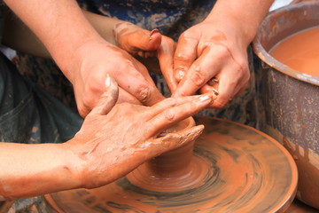 Hands of a potter close-up