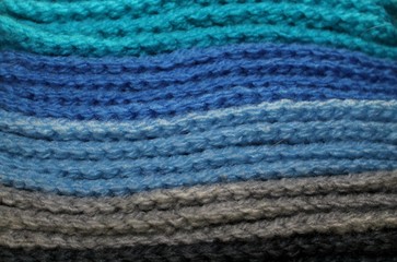 Colorful blue and gray design background of knitted woolen elements in a pale