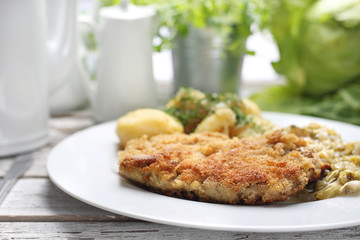 Traditional pork chop with potatoes and fried cabbage.