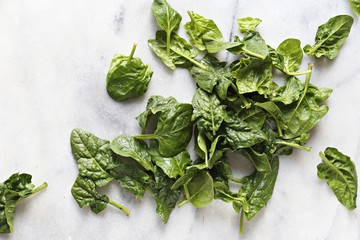 Spinach. Flat lay of fresh spinach on marble table