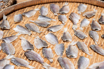 Make dry fish with sunny on bamboo basket. Salted fish dries on threshing basket.