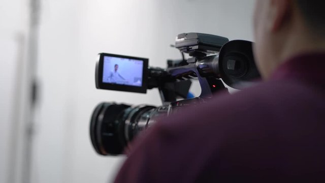 The video lessons on English language, Camera operator working with a cinema broadcast TV camera