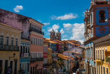 Historic city center of Pelourinho features brightly lit skyline of colonial architecture on a broad cobblestone hill in Salvador, Brazil