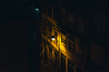 Portugal. Porto city street shot in the night. Old street laterne in the dark night. Mystic street shot