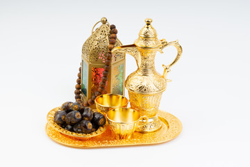 Premium dates, lantern and arabic coffee mug on white background. Selective focus, copy space and Ramadan Kareem concept