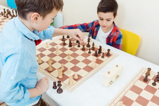 Two Boys Playing Chess In Tournament As Sport