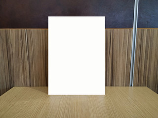 white frame on wooden table-can be used mock up for your idea