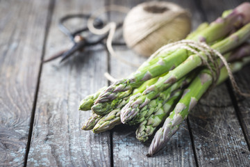 Bunch of fresh asparagus on wooden table