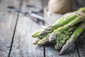 Bunch of fresh asparagus on wooden table