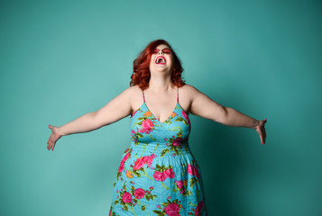 Successful overweight fat woman surprised happy laughing shouting screaming with hands spread raised up looking up screaming with pink hair on blue mint background