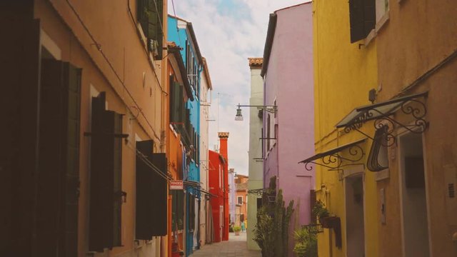 Narrow street with colorful houses of Burano, Italy.