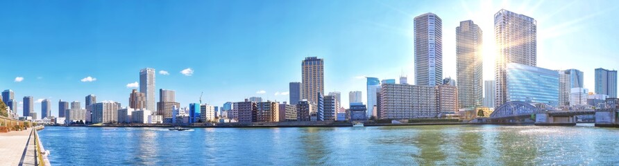 Panoramic view of winter Sumida river under blue sky in Tokyo wi