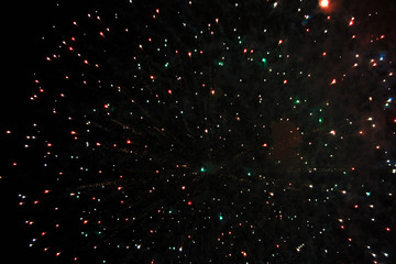 Star scattering of bright yellow and green firework lights during Halloween, Christmas,...