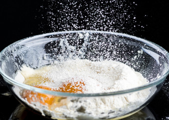 Add eggs and flour to a transparent bowl for making batter.